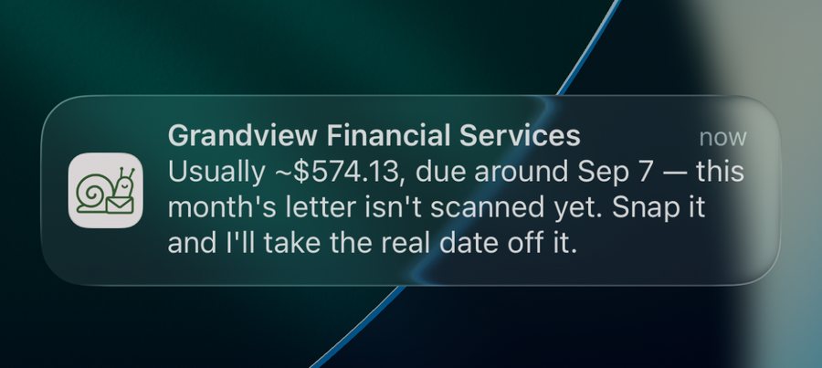 A Snailbox notification on the iPhone lock screen for a sample tracked bill: usually about $574.13, due around September 7, and this month's letter isn't scanned yet.